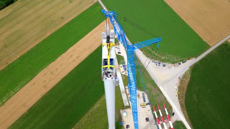 bird's eye view over wind turbine head under construction - drone shot