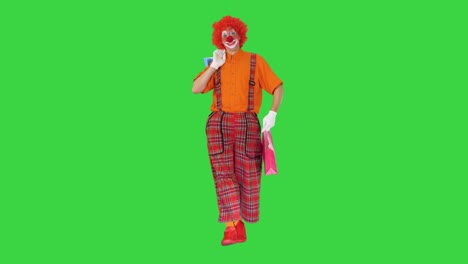 funny clown walking with shopping bags on a green screen, chroma key