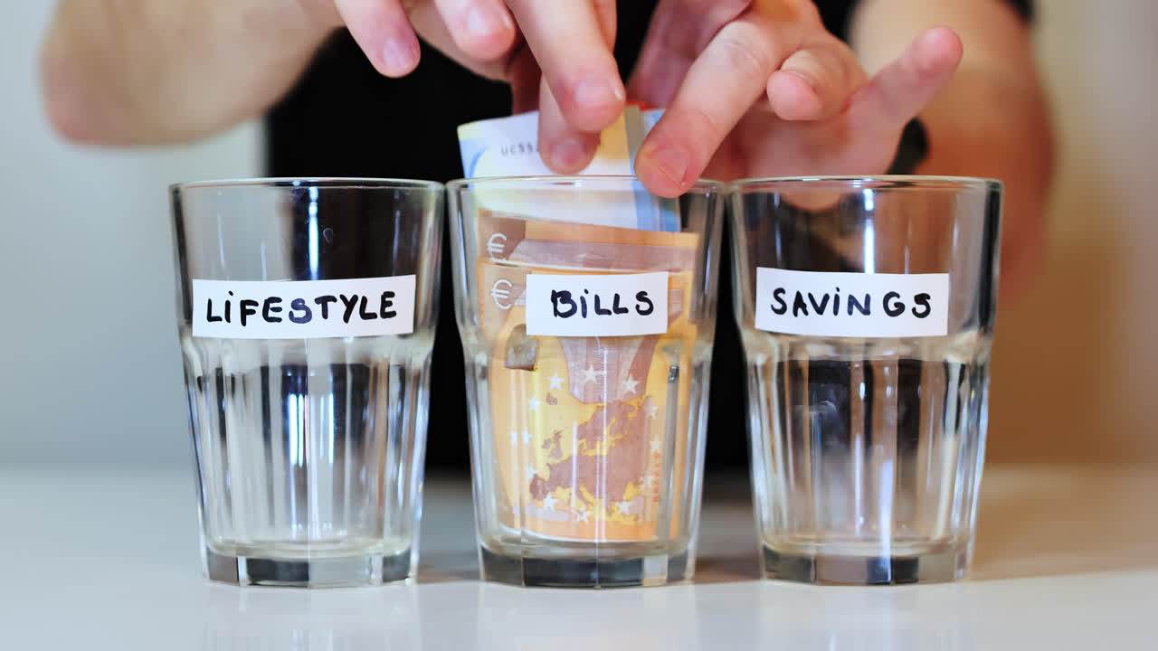 Euro bills taken from labeled bills glass during economic struggle, uncertainty