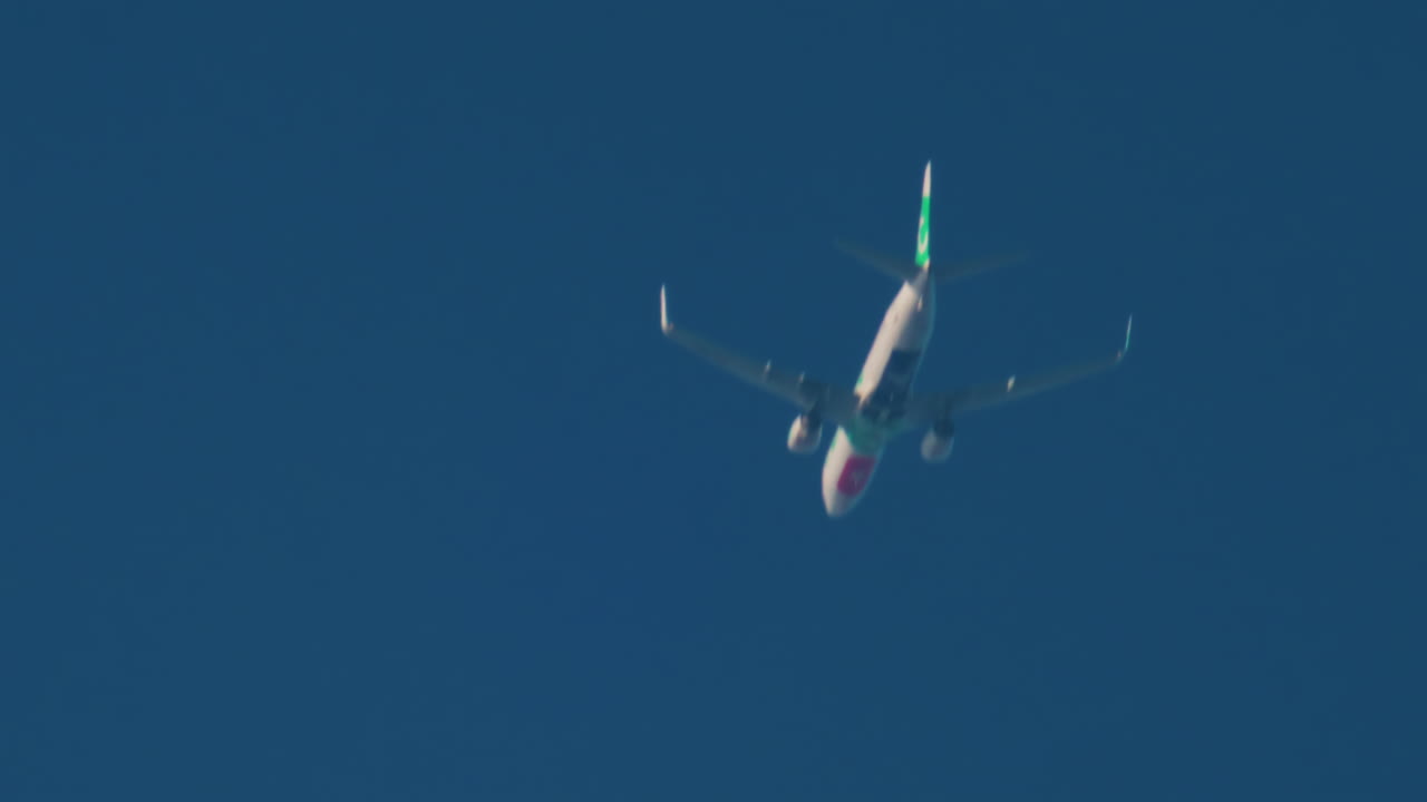 Cannes, France - October 11, 2025: An airplane passes overhead in a clear blue sky, seen from below