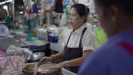 woman selling chicken at a market