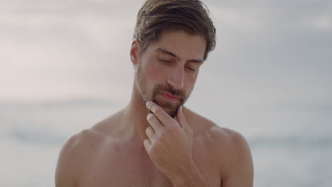 portrait of attractive shirtless man looking pensive smiling enjoying healthy lifestyle on beach slow motion