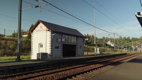 The-phone-lines-and-terminal-building-in-a-deserted-railway-station,-reveal