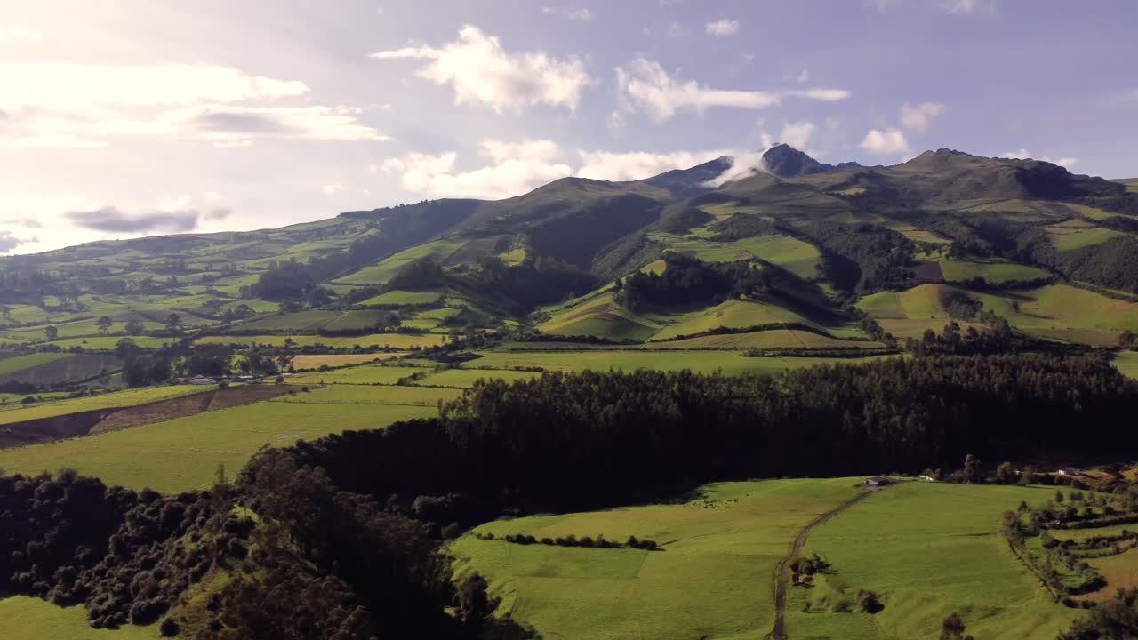 Lateral drone shot from the Tucuso neighborhood with the background of the Rumi&ntilde;ahui volcano on a sunny day in the city of Machachi, Ecuador