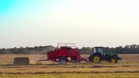 haymaking tractor on field. agriculture machine harvesting hay in fields