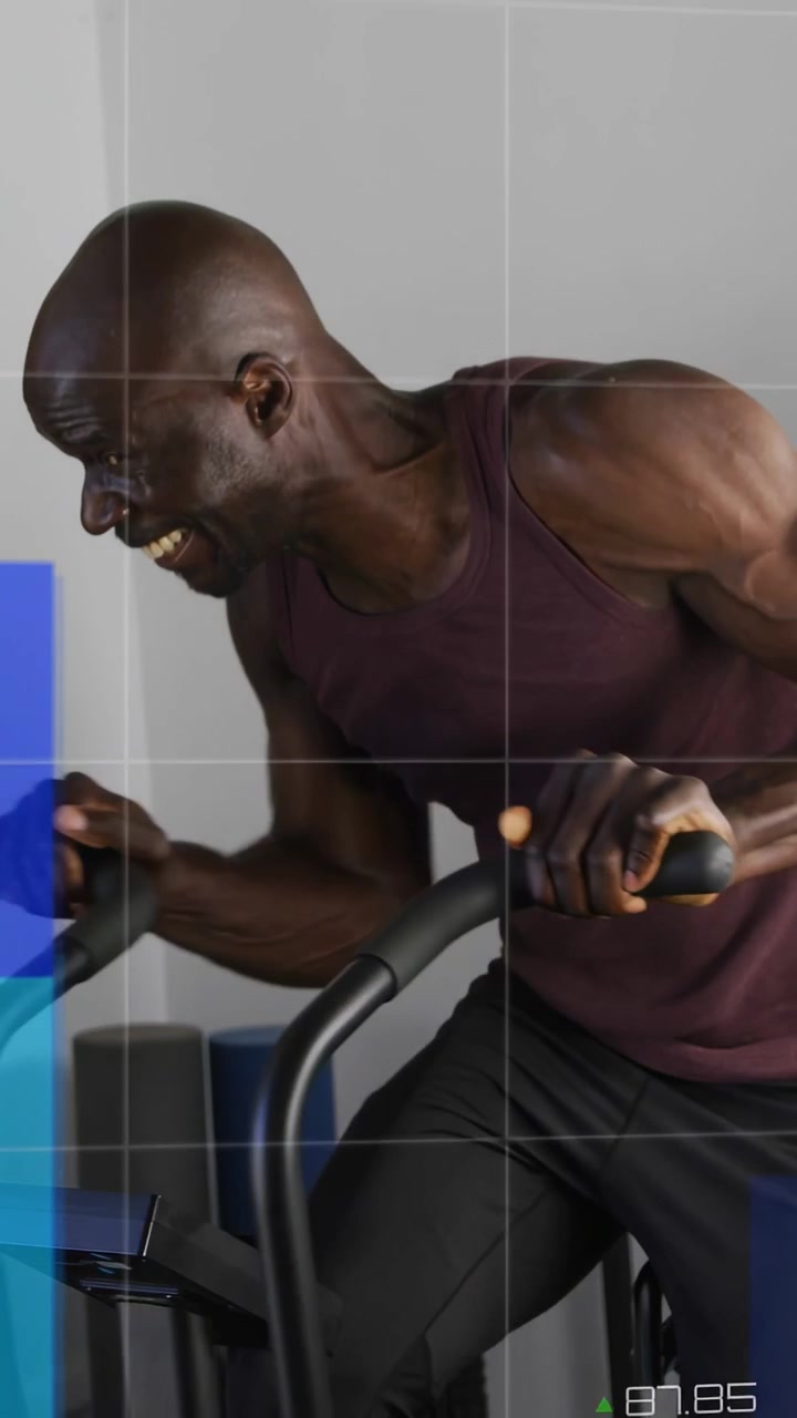 Mounting bike and gripping bars, mature man pedaling hard for fitness while blue HUD metrics rising