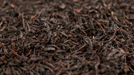 té negro seco en bucle giratorio fondo de primer plano de fotograma completo