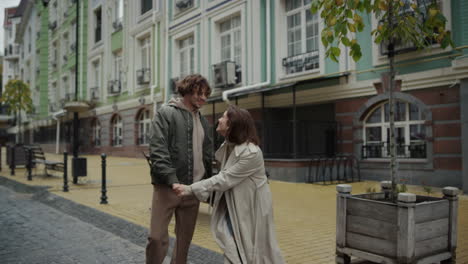 Affectionate-couple-kissing-on-city-street.-Man-and-woman-enjoying-each-other.