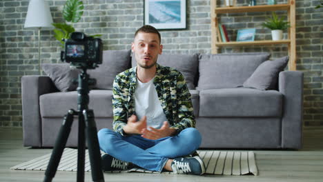 man sitting on floor vlogging