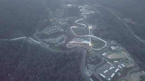 aerial view of a bobsleigh track in a mountain resort