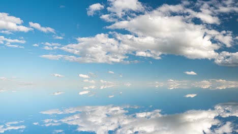 futuristic background consisting of time lapse clip of white fluffy clouds over blue sky and their reflection, video loop