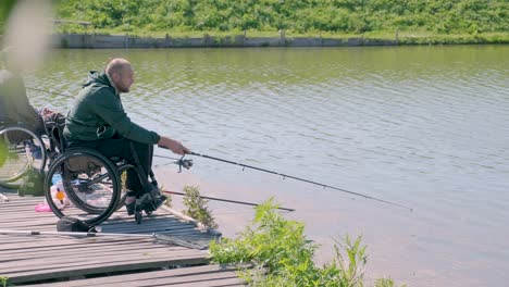 man with disabilities fishing at a lake. wheelchair. camping. summertime