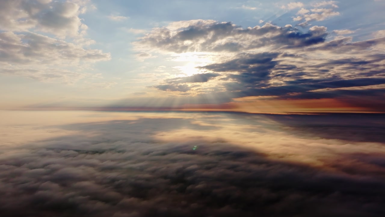 Sun rays over cloud layer horizon depicting hope and global climate transition