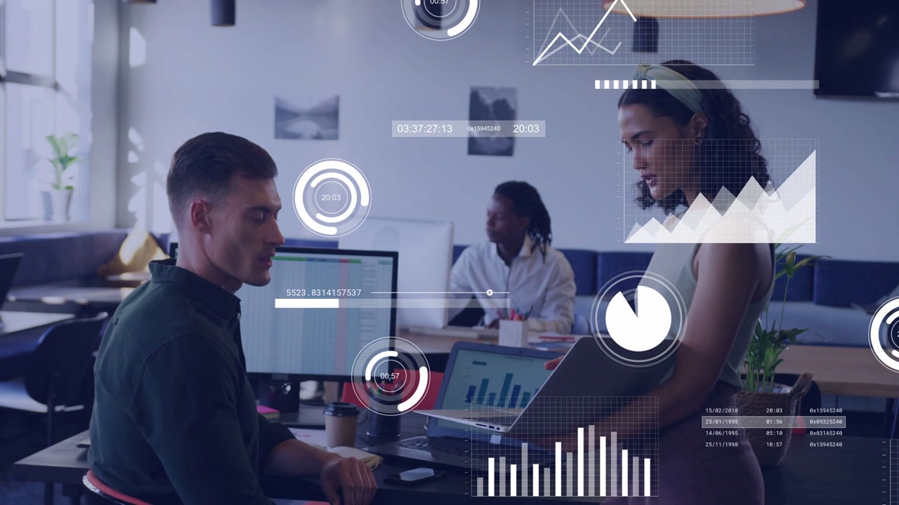 Woman presenting laptop to colleague for business review, animated charts overlaying screens