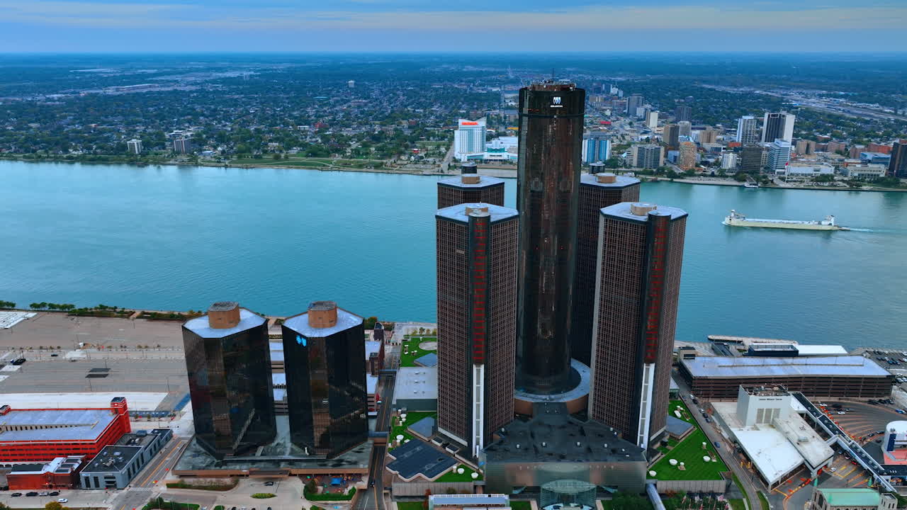 Detroit, USA, 28 July 2025: Flight along the buildings of Renaissance Center in Detroit midtown, Michigan, USA. Ship moves by the riverscape at backdrop