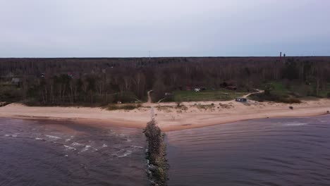 stone made mole in sea and forestry landscape, flying over drone view