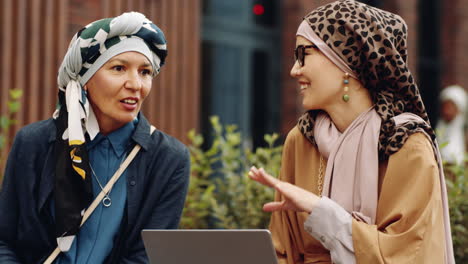 female colleagues talking outdoors