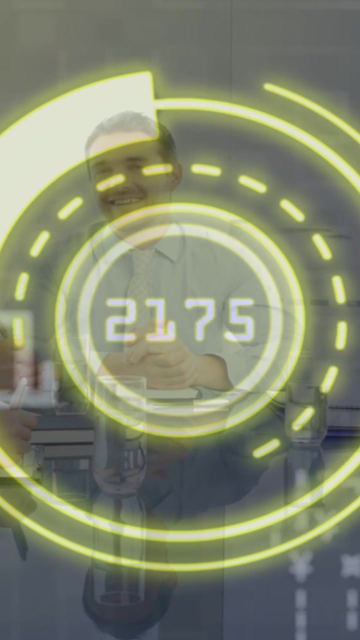 Male tech host standing at counter, HUD cycling numbers and rings, causing gestures and explaining