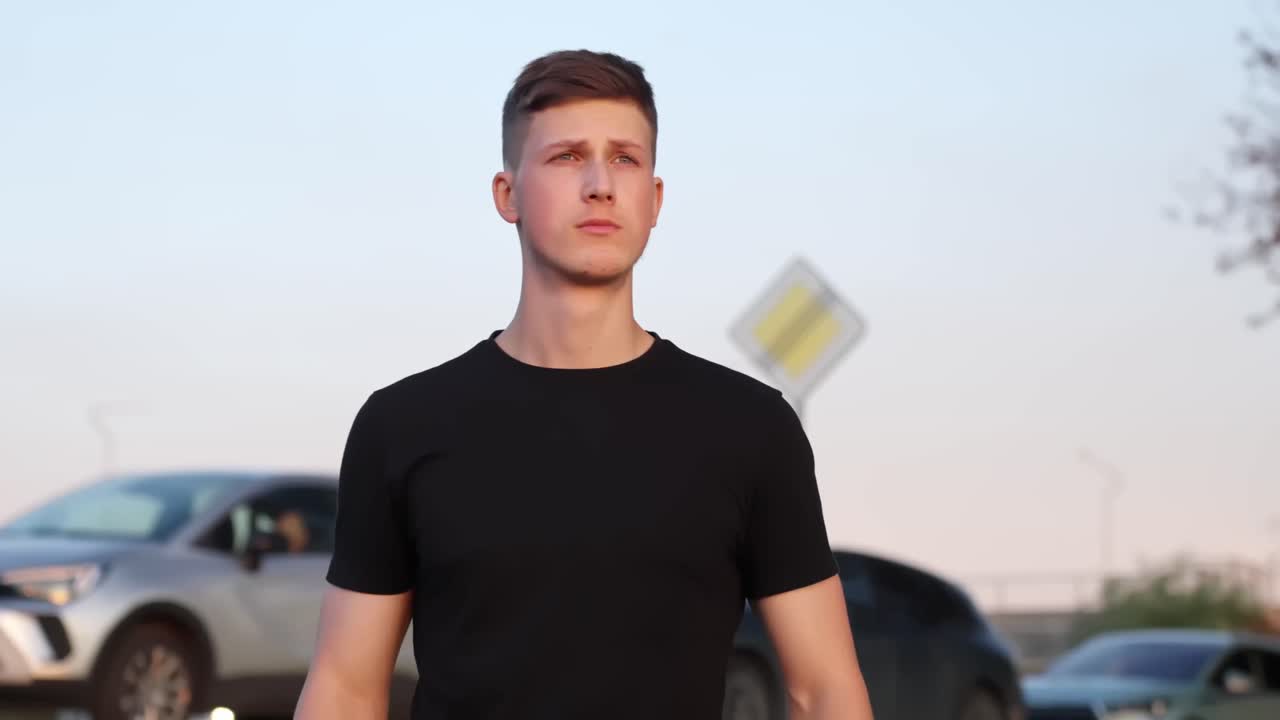 Worker outdoors putting on safety glasses while wearing a hard hat, preparing for a construction or inspection task in a bright, open environment