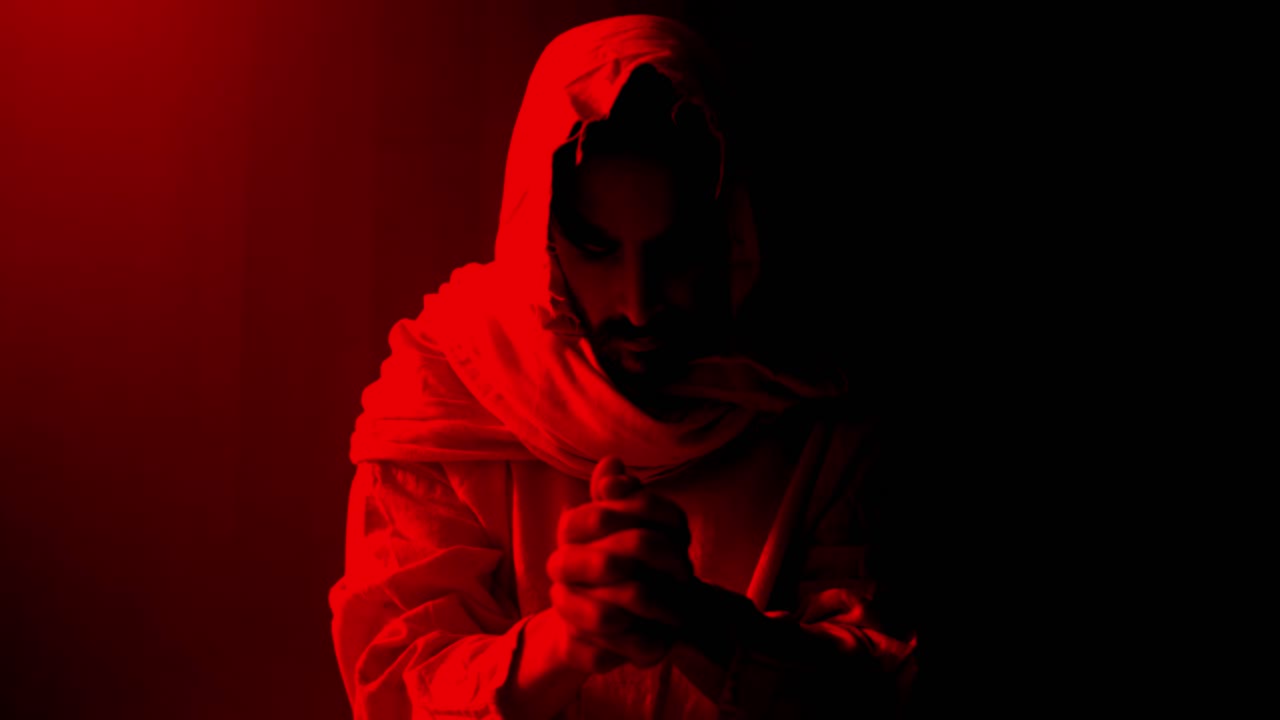 Jesus Christ folding hands and praying. Christianity, Easter visual, bible scene or temptation, prayer, worship visual.