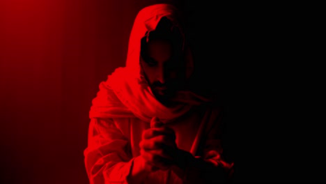 jesus christ folding hands and praying. christianity, easter visual, bible scene or temptation, prayer, worship visual.