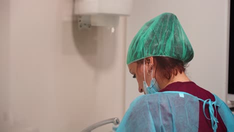 fotografía de primer plano de una higienista en traje de ppe y máscara facial, clínica dental
