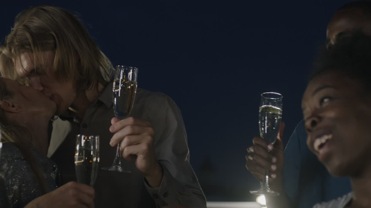 Friends Celebrating on a Rooftop at Night