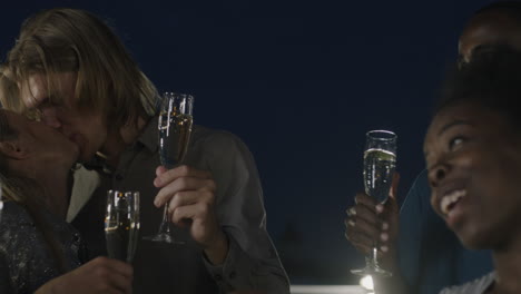 friends celebrating on a rooftop at night
