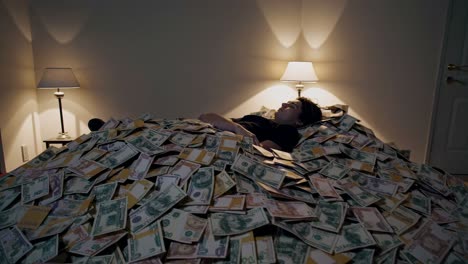 man sleeping on a pile of money