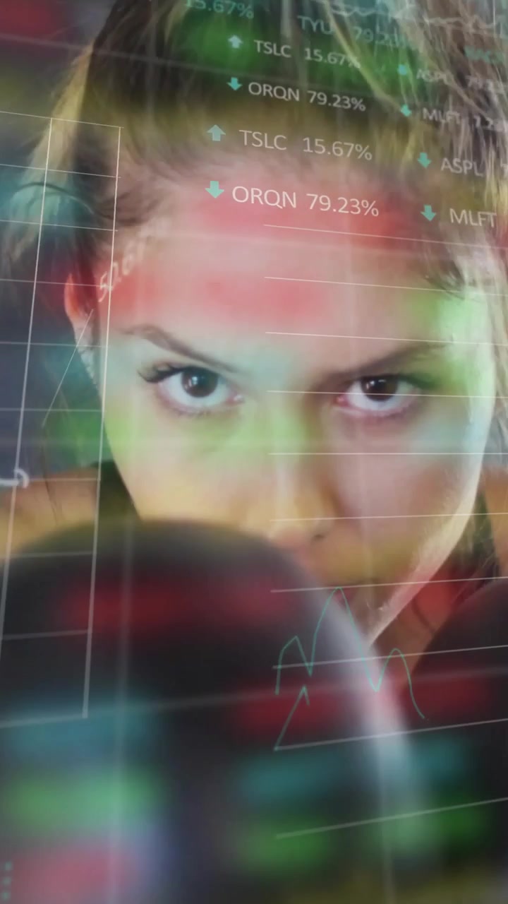 Vertical video: Female boxer jabbing camera, causing shifting finance charts showing market pulse