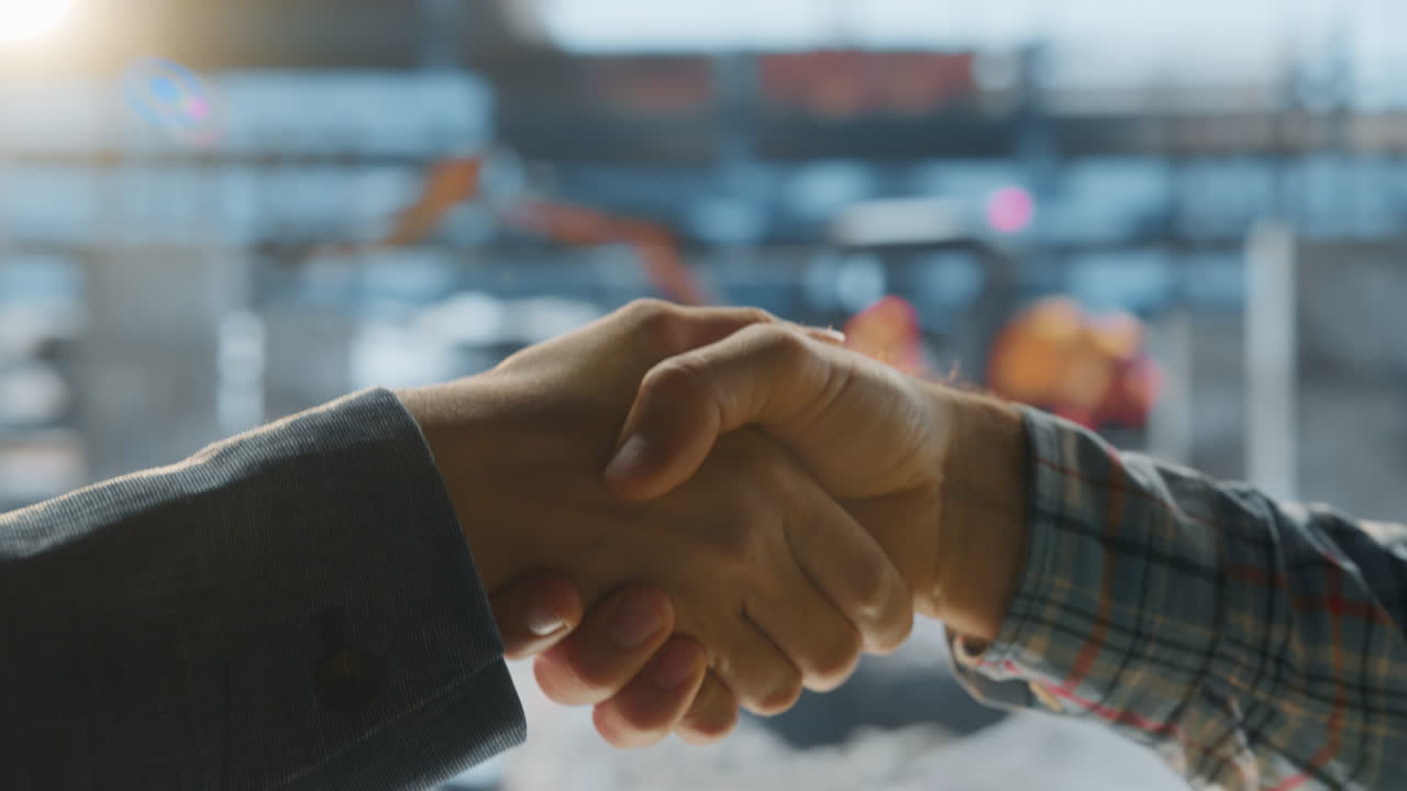 Hands Exchanging Keys and Sealing a Deal with a Handshake
