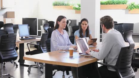 Executive-discussing-with-each-other-while-using-laptop-4k