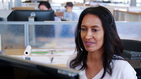 Mixed-race-woman-working-at-a-call-centre,-close-up