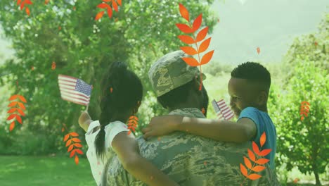Animation-Von-Blättern-über-Der-Rückansicht-Eines-Afroamerikanischen-Soldatenvaters,-Der-Kinder-Mit-US-Flaggen-Hält