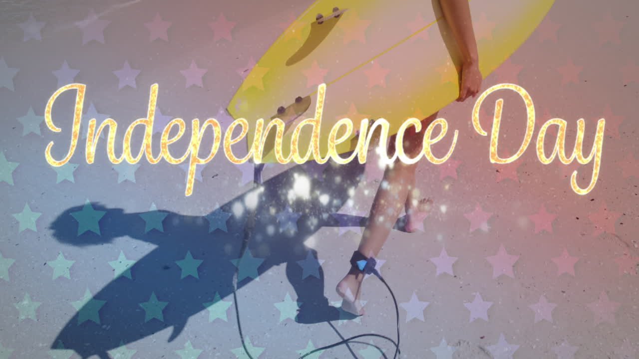 Independence day text against mid section of woman walking with surf board on the beach