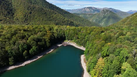 mountain lake in a green forest valley