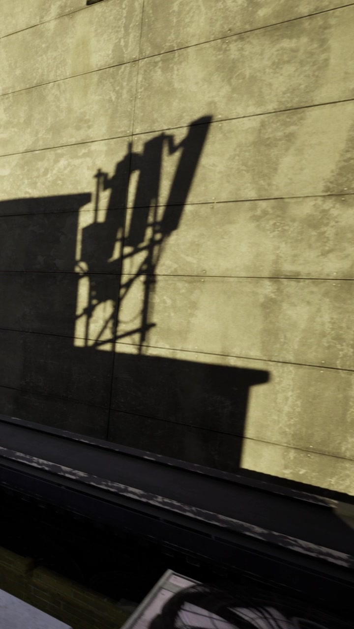 Creative shadows dance on the textured wall of an urban building at dusk