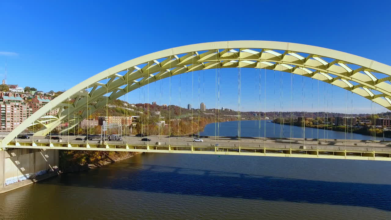 Drone shot moving towards busy traffic on bridge going into Cincinnati Ohio