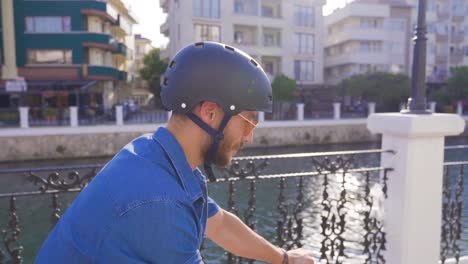 young man cycling on busy street.