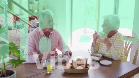 animation of vibes text in red and white over happy caucasian senior couple having breakfast at home