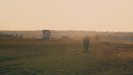 girls-walk-dancing-on-meadow-in-morning-slow-motion