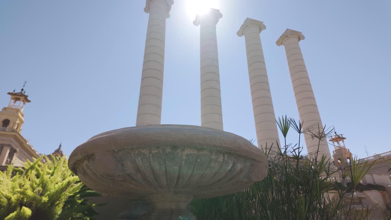 Fountain Near Columns at Museu Nacional d'Art de Catalunya in Daylight In Barcelona. Pan Right, Low Angle View