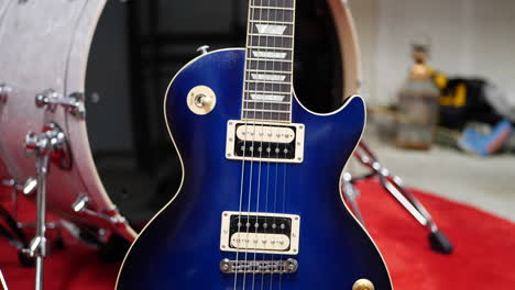 a vintage blue electric guitar on a concert stage in a rock and roll garage band setting