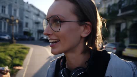 Close-up-footage-of-a-young-woman-face-in-glasses-taking-and-ice-cream-from-malee-hand.-Friendship,-having-fun,-smiling.-Outside