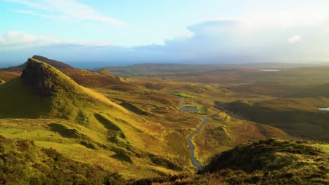 Sheep-are-seen-grazing-on-the-Quiraing-landslip-and-cars-drive-by-on-the-Isle-of-Skye-in-Scotland