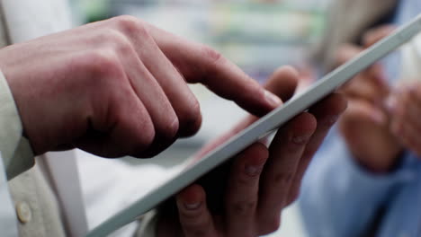 person using tablet next to the client