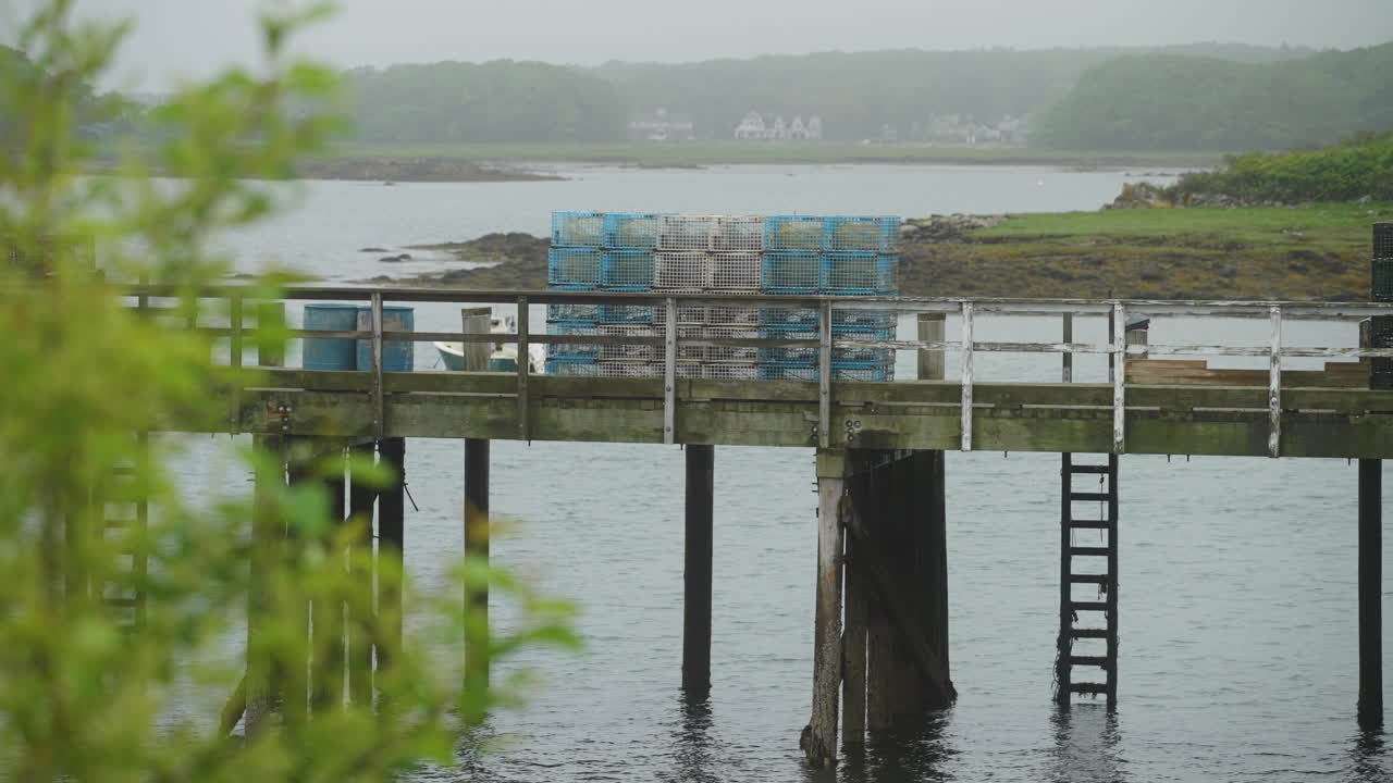 Commercial Lobster fishing traps on pier with moody fog cloudy weather 4k 60p