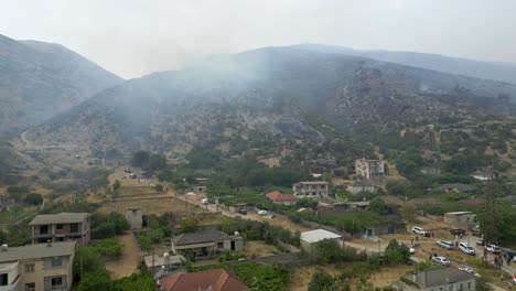 Drone-shot-of-wildfires-in-the-mountains-closing-in-on-the-village