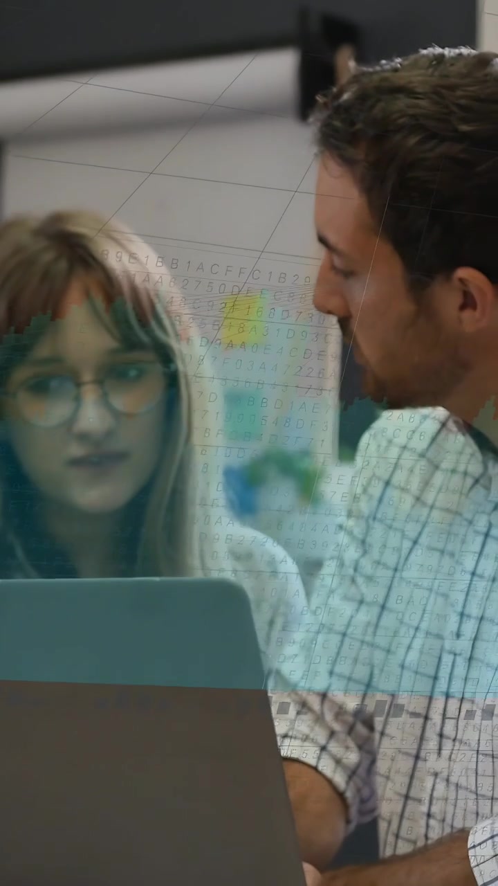 Vertical video: Woman sitting at laptop, man moving closer, starting business review of laptop docs