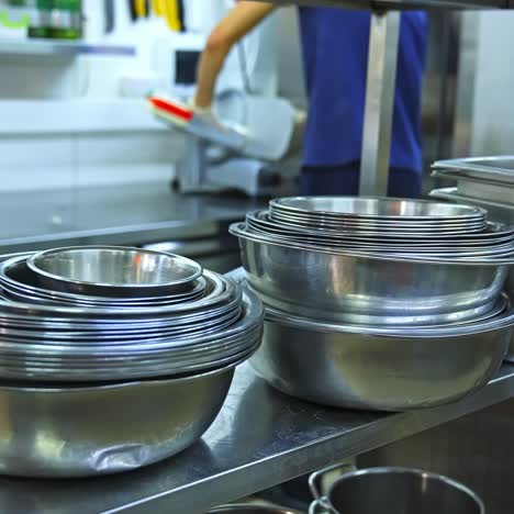 an industrial kitchen utensils close up. stainless steel bowl and plastic container at commercial kitchen